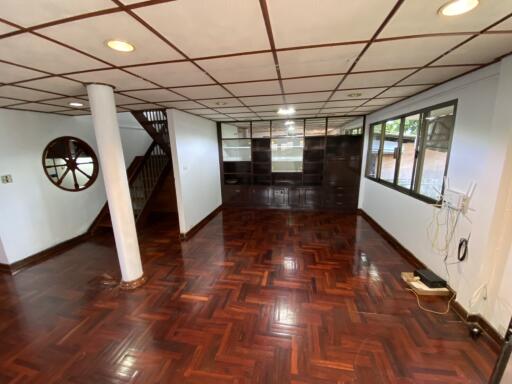 Spacious living room with wooden floor and large windows