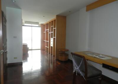 Bright living space with wooden flooring and built-in shelving