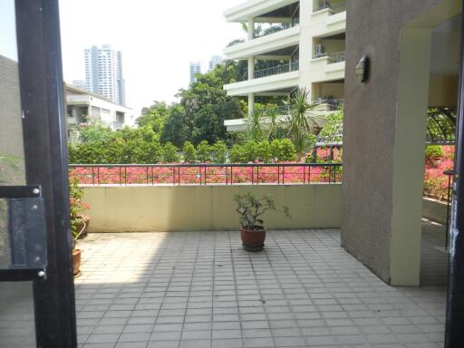 Spacious balcony with potted plants and city view