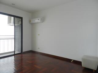 Spacious living room with wooden flooring and large window