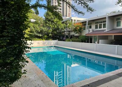 Outdoor swimming pool with surrounding greenery