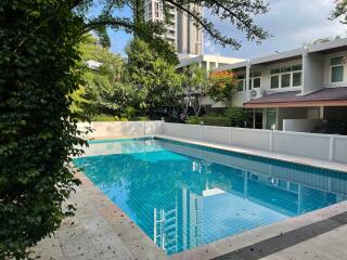 Outdoor swimming pool with surrounding greenery