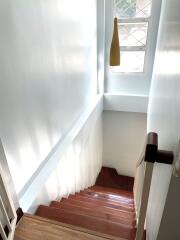 Staircase with wooden steps and a window