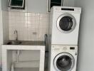 Laundry room with stacked washer and dryer