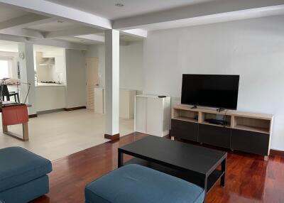 Spacious living room with adjacent kitchen