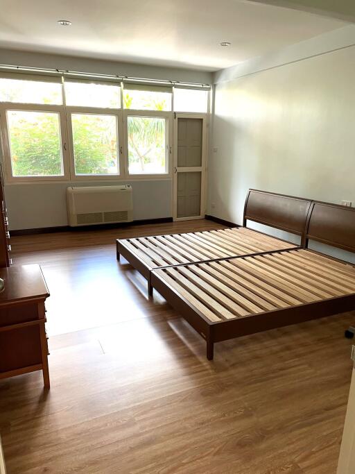 Spacious bedroom with wooden bed frames and natural lighting