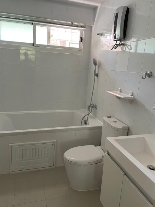 Modern bathroom with bathtub and wall-mounted water heater