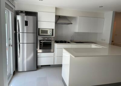 Modern kitchen with stainless steel appliances and white cabinetry