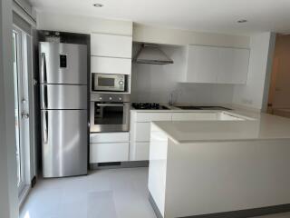 Modern kitchen with stainless steel appliances and white cabinetry