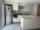 Modern kitchen with stainless steel appliances and white cabinetry