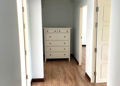 Hallway with wooden floor and dresser