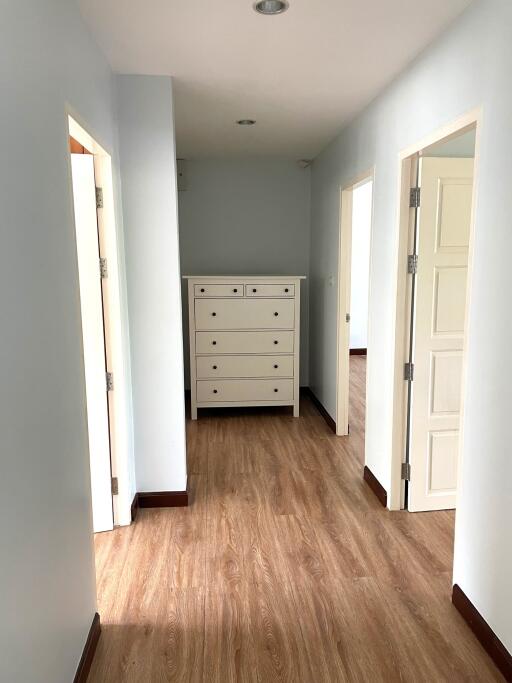 Hallway with wooden floor and dresser