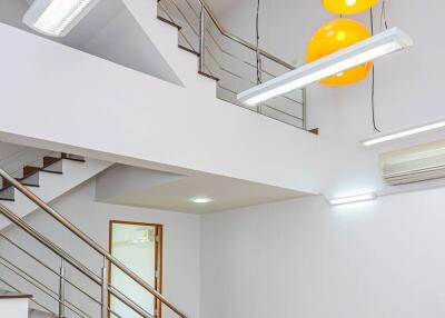 Modern staircase with wooden flooring and contemporary lighting