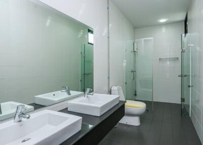 Modern bathroom with double sinks and a spacious shower area