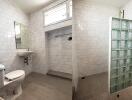 Modern bathroom with tiled walls and glass-block shower