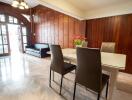 Modern dining area with wooden paneling and marble floor