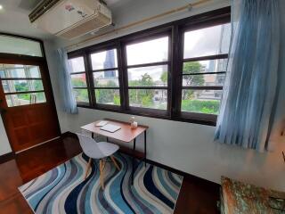 Study room with desk, chair, large windows, and air conditioning