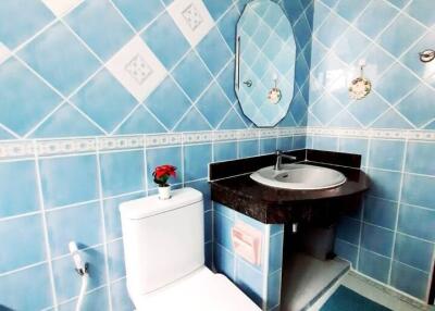 Bathroom with blue tiled walls and modern fixtures