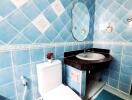 Bathroom with blue tiled walls and modern fixtures