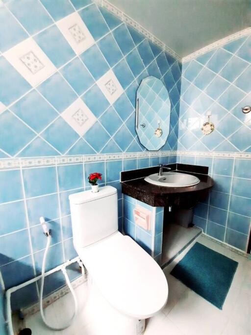 Bathroom with blue tiled walls and modern fixtures