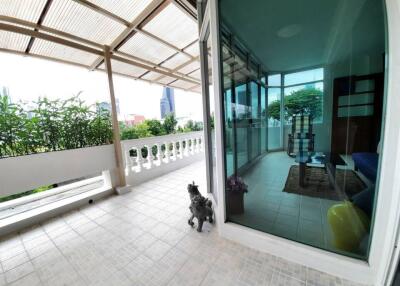 spacious balcony with view of city and greenery