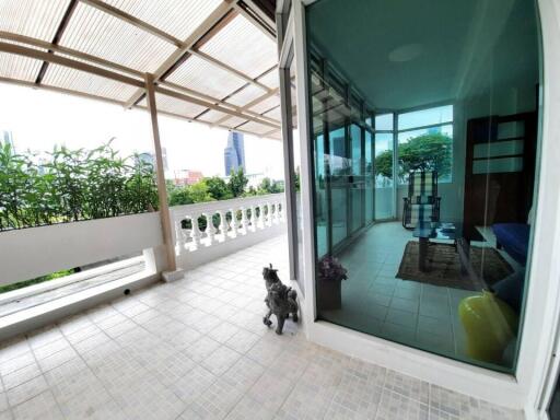 spacious balcony with view of city and greenery