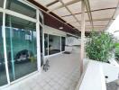 Large balcony with a view of the city, plants, and modern decor