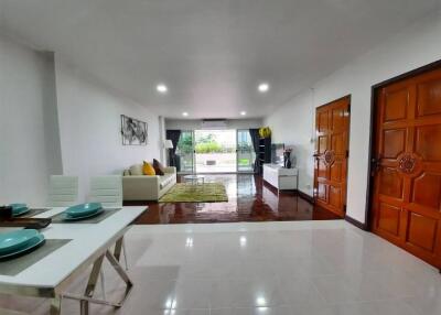 Spacious modern living room with dining area and large window