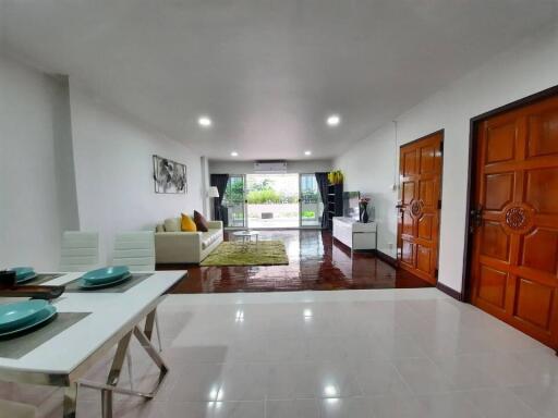 Spacious modern living room with dining area and large window