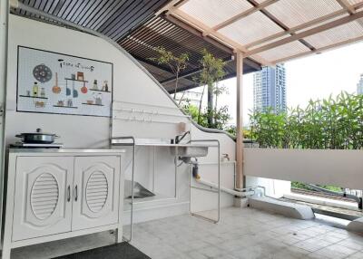 Outdoor kitchen with modern amenities and greenery