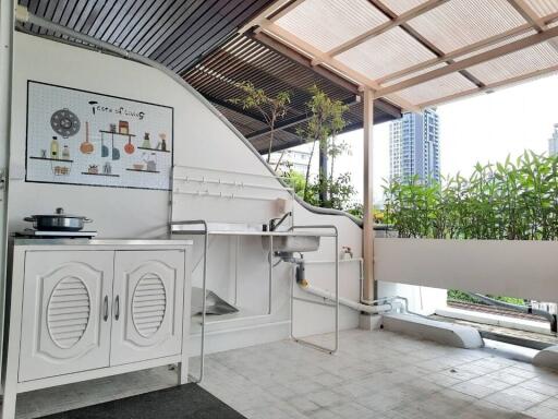 Outdoor kitchen with modern amenities and greenery