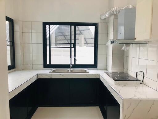 Modern kitchen with black and white marble countertops