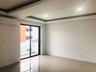 Bright empty living room with large windows and air conditioning