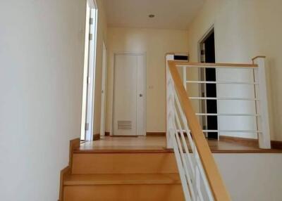 Staircase and hallway leading to upper floor doors