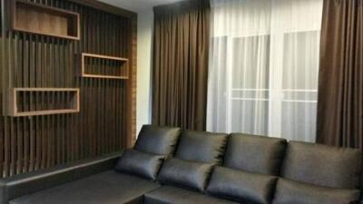 Modern living room with dark sofa and decorative shelving