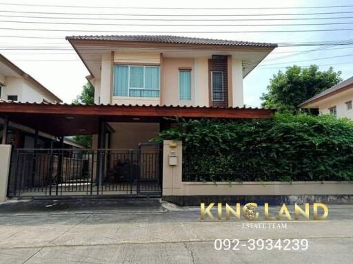 Two-story house with carport