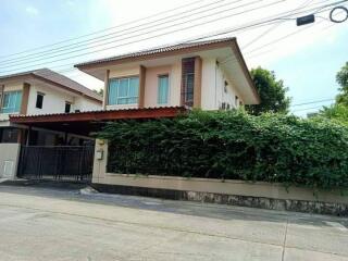 Two-story house with a front yard and driveway