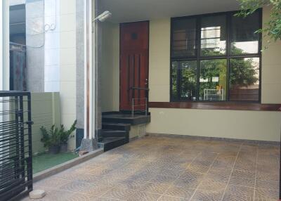 Covered porch with tiled flooring and modern entrance