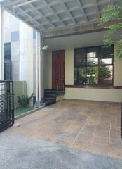 Covered porch with tiled flooring and modern entrance