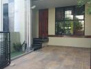 Covered porch with tiled flooring and modern entrance