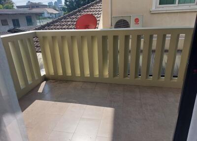 Small balcony with railing, tiled floor, and an air conditioning unit on the wall