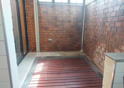 Covered laundry area with tiled walls