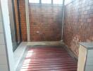 Covered laundry area with tiled walls