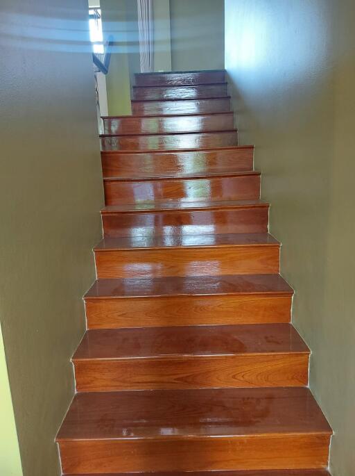 Polished wooden staircase with brown steps