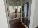 Hallway with wooden floor and mirrored closets