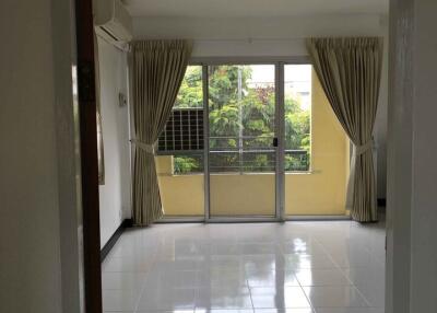 Bright living room with large windows and tiled floor