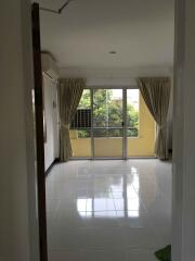 Bright living room with large windows and tiled floor