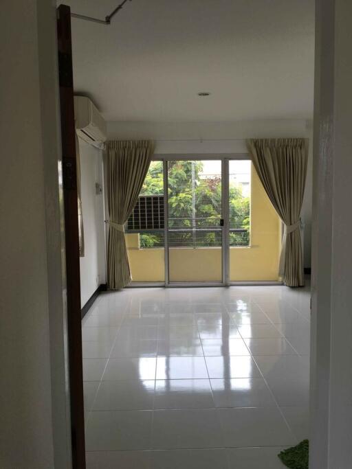 Bright living room with large windows and tiled floor