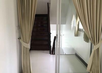 Hallway with stairs and sliding glass door