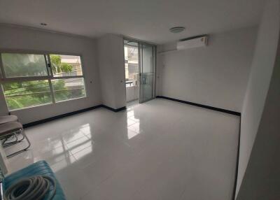 Spacious main living area with large window and balcony access